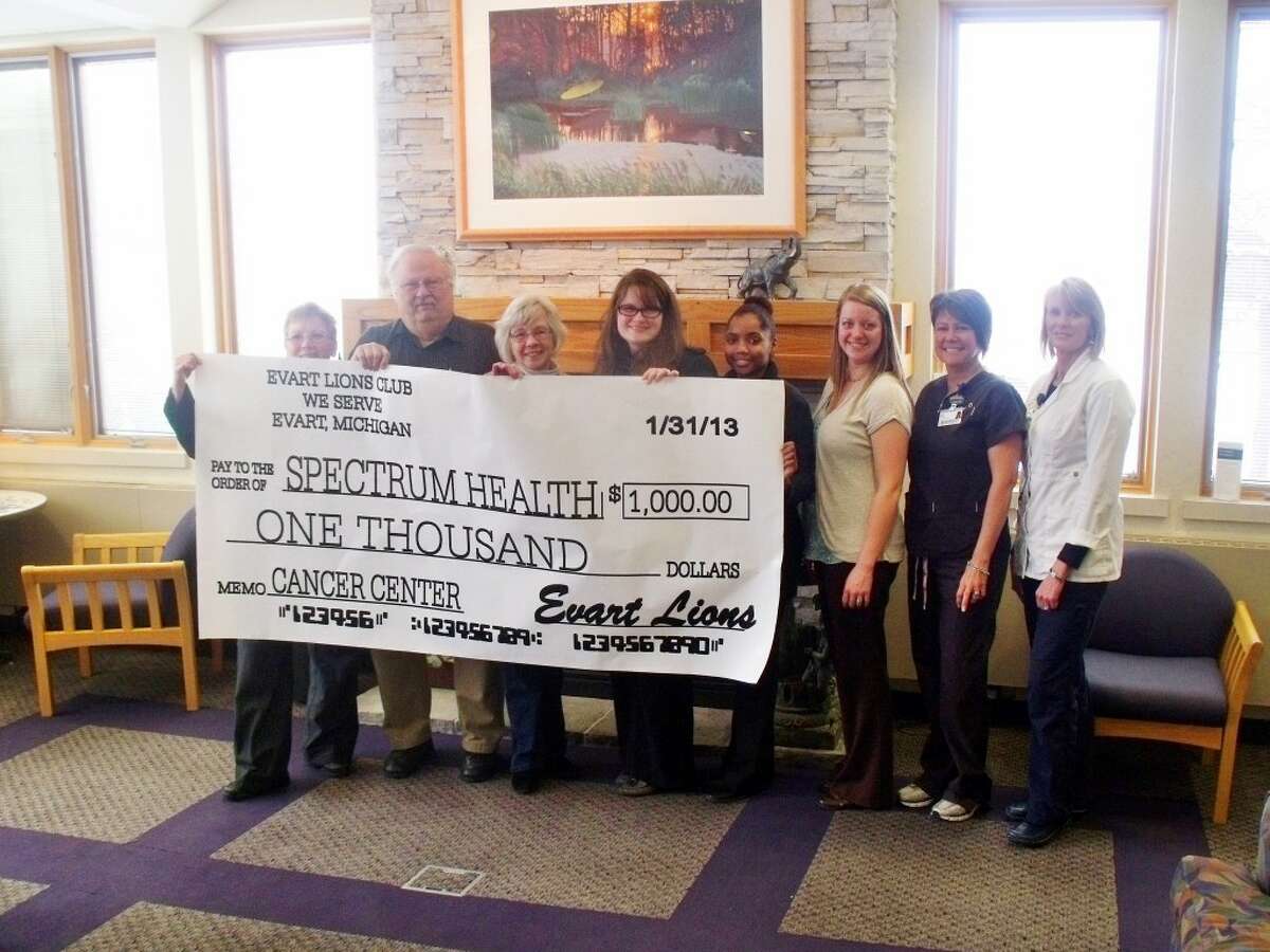 THE CHECK: Irene Balowski, director of cancer services, accepts a donation from the Evart Lions Club representatives; Terese Whitten and Bill Wilder, Christie Carlson, development director, Ashley Williams, Ferris State University intern, Katelyn Johnson, Foundation assistant, Amy Bomay, radiation therapist and Sandra McGrath, RN.