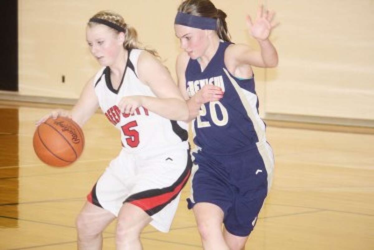 WATCH OUT: Reed City's Makenzie Switzer (left) tries to drive past a Lakeview defender during Friday's basketball action. (Pioneer photo/John Raffel)
