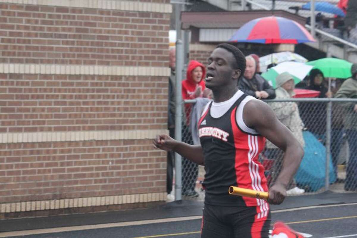Phillip Jones crosses the final line first in the 400 relay.