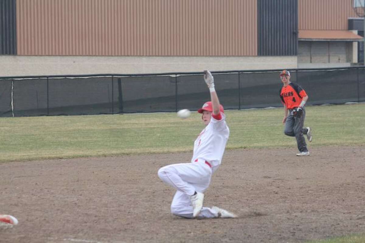 Cody Kailng slides ahead of the throw into third base.