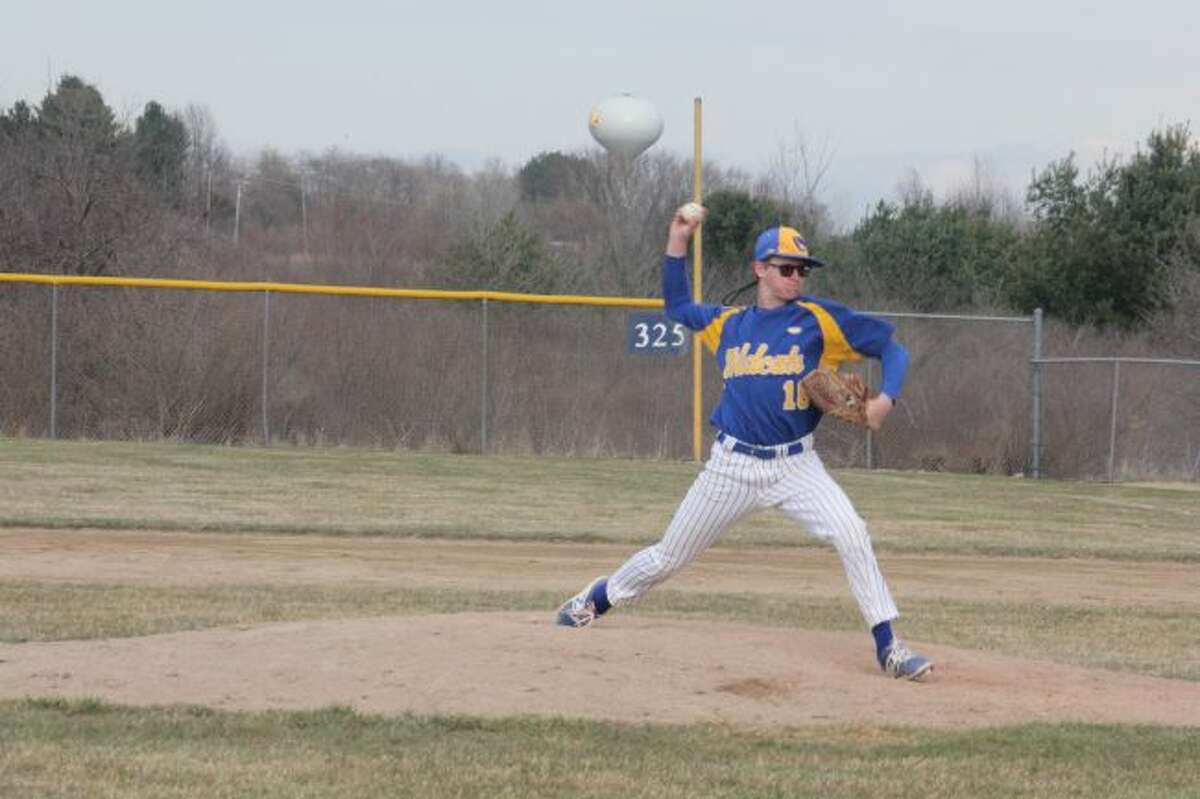 Evart's Parker Henry throws a pitch.
