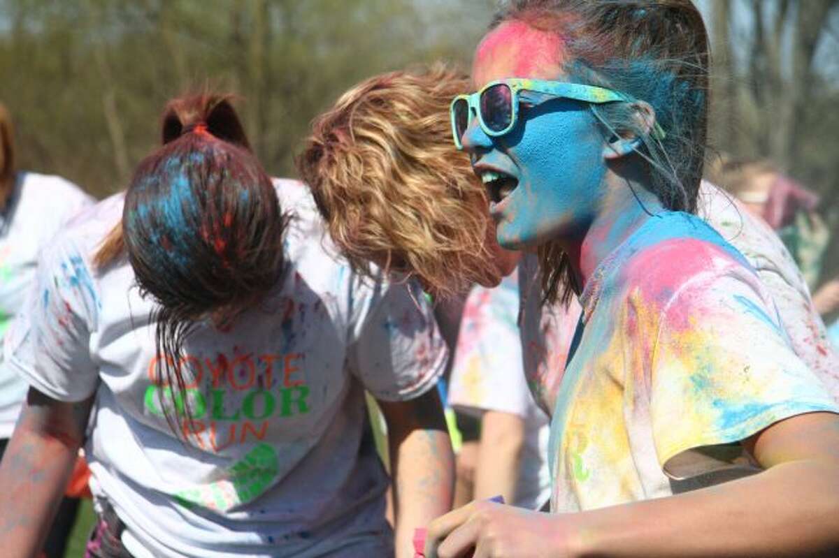 Colorful dye covers participants of the Coyote Color Run in 2018. This year's event takes off at 6 p.m. Aug. 18 from the Reed City Depot. (Herald Review file photo)
