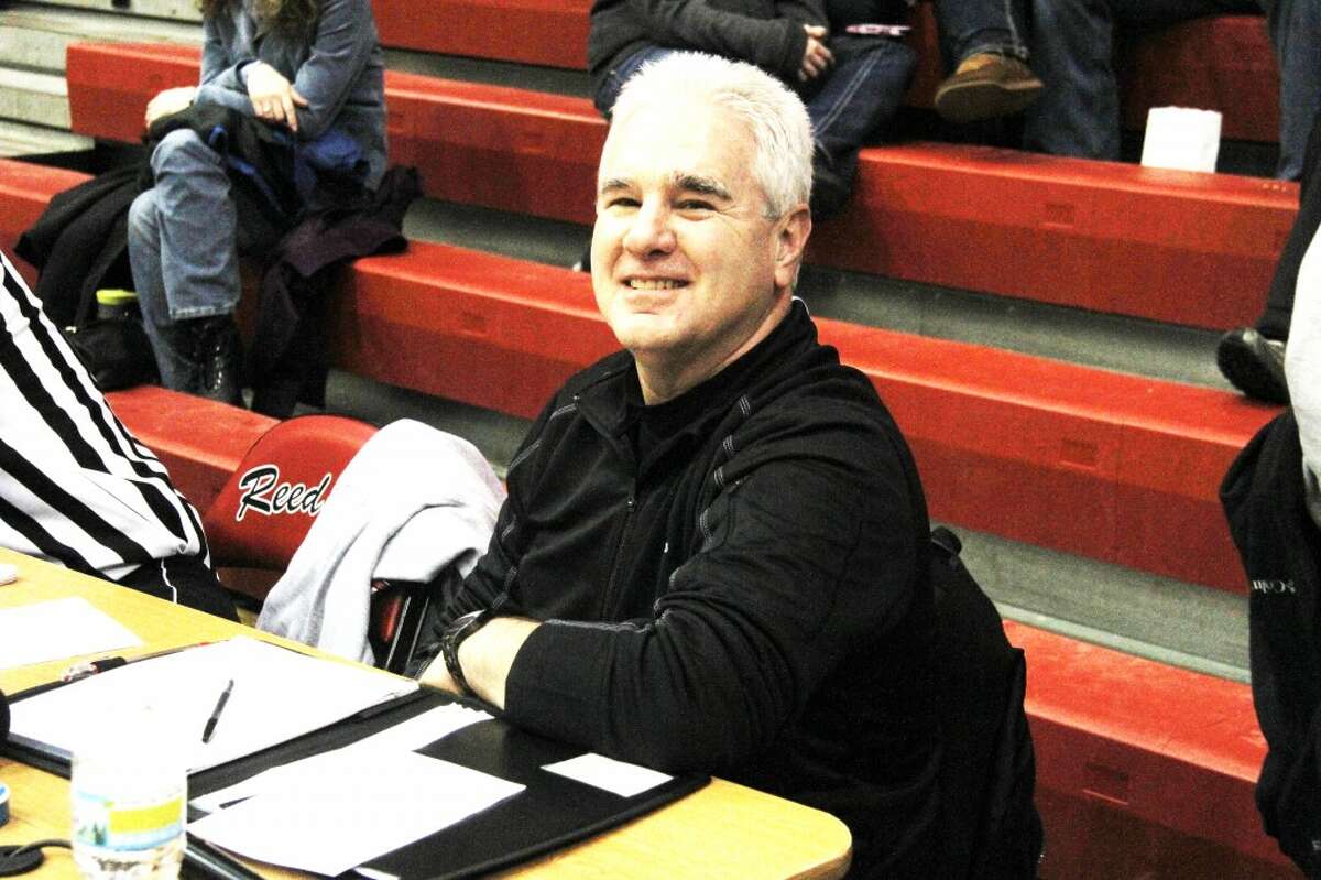 TELLING YOU THE SCORE: John Williams has announced Reed City sporting events for 41 years. When he isn’t in the announcers chair, Williams spends his time selling water-treatment equipment and plumbing supplies as a co-owner of D&E Supply Company in Reed City. (Herald Review photo/Martin Slagter)