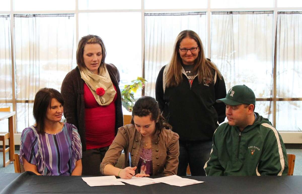 LETTER OF INTENT: Cayman Gatt of Pine River signed her letter of intent last week for Davenport softball. Pictured are from left to right Shirley Snyder (mother sitting), Pine River Varsity Softball coach Laura Mumby (standing), Cayman Gatt (signing), Davenport Assistant Coach Kristin Miedema (standing), father Al Gatt (sitting). (Courtesy photo)