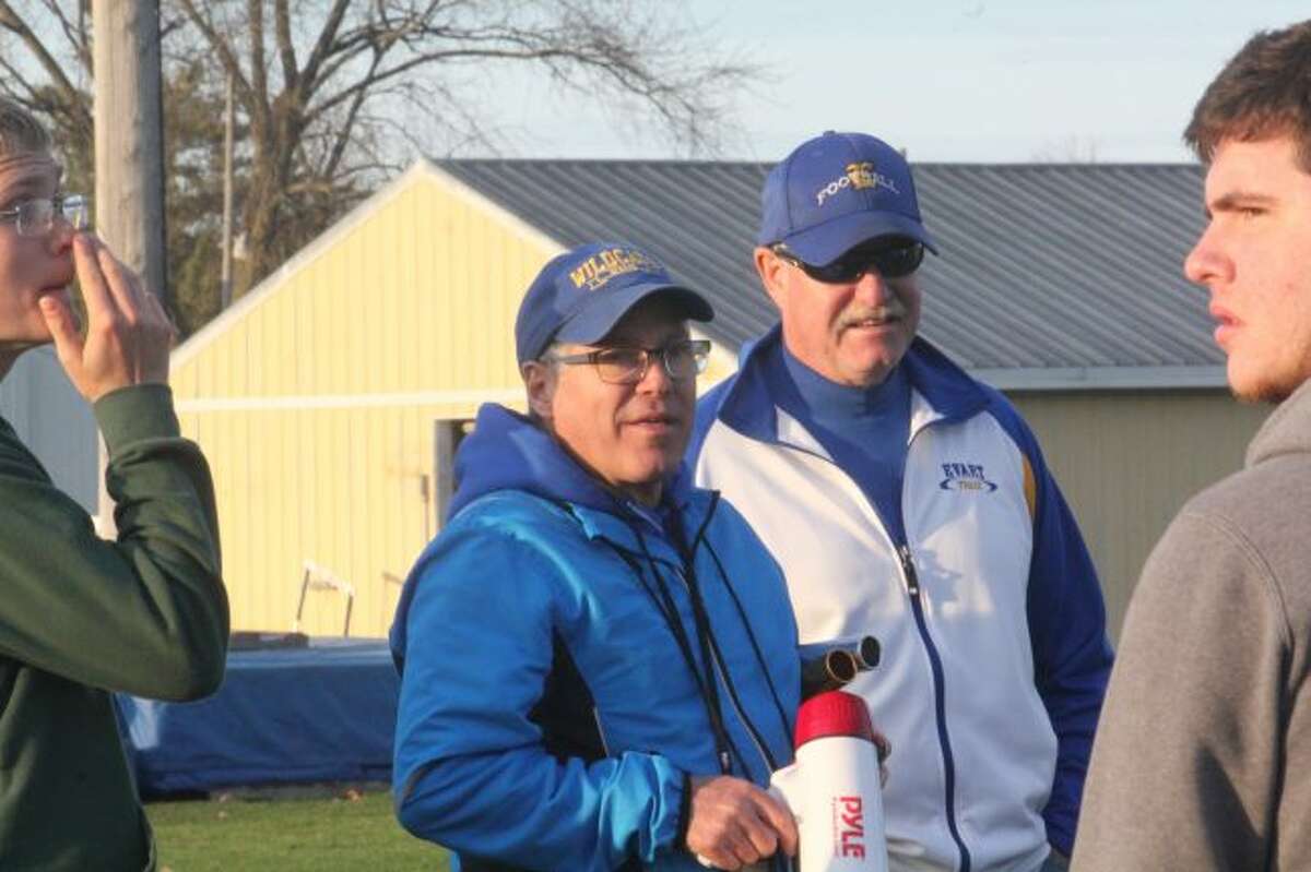 Coach Dennis Peacock talks with his team after a meet.