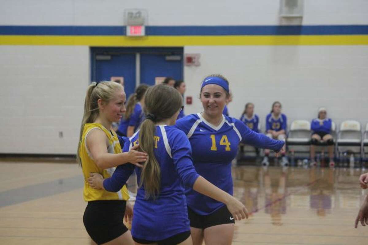 Evart volleyball team celebrates a point.