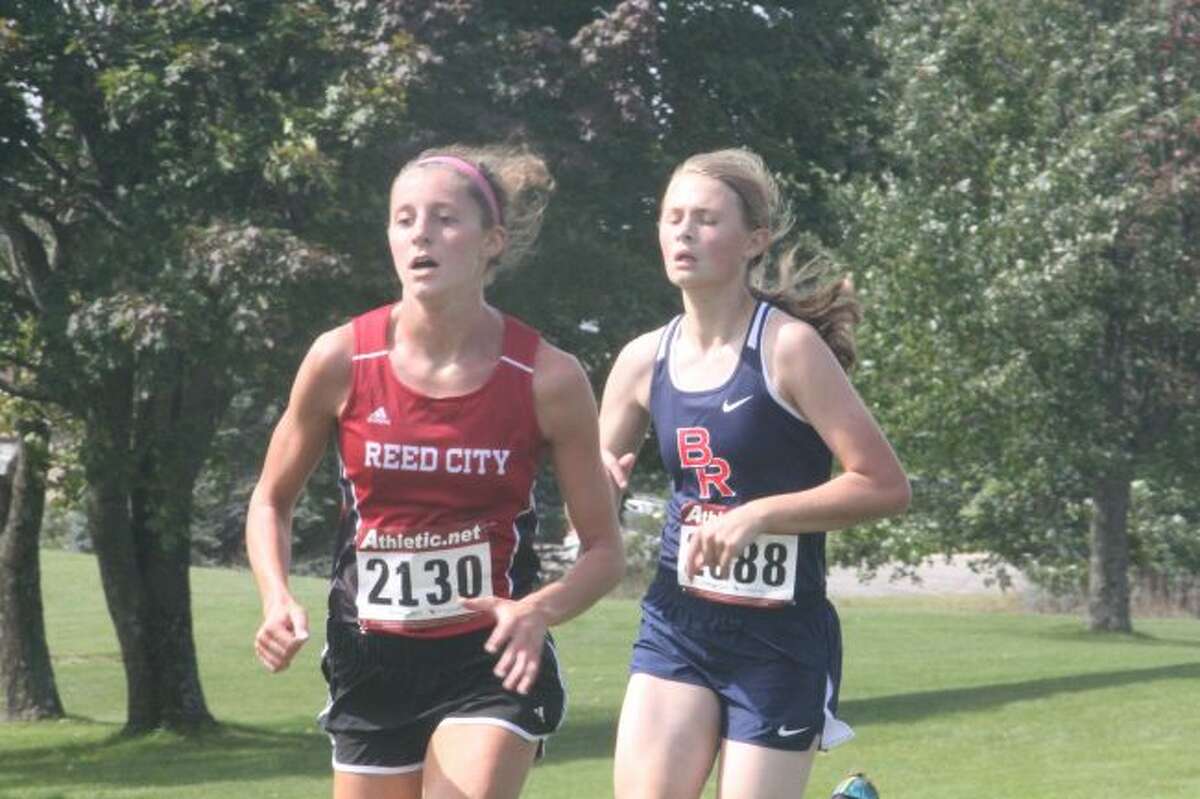 Reed City's Taylor Harrison (left) heads to the finish line at Katke Golf Course/