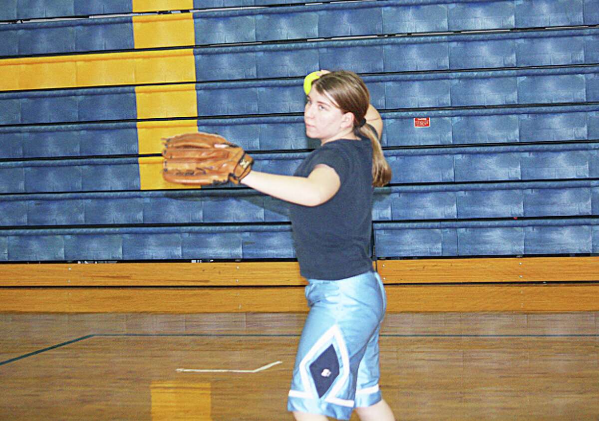 WARMING UP: Sam Bressler works on her throwing during an Evart softball practice last week. (Herald Review photo/John Raffel)