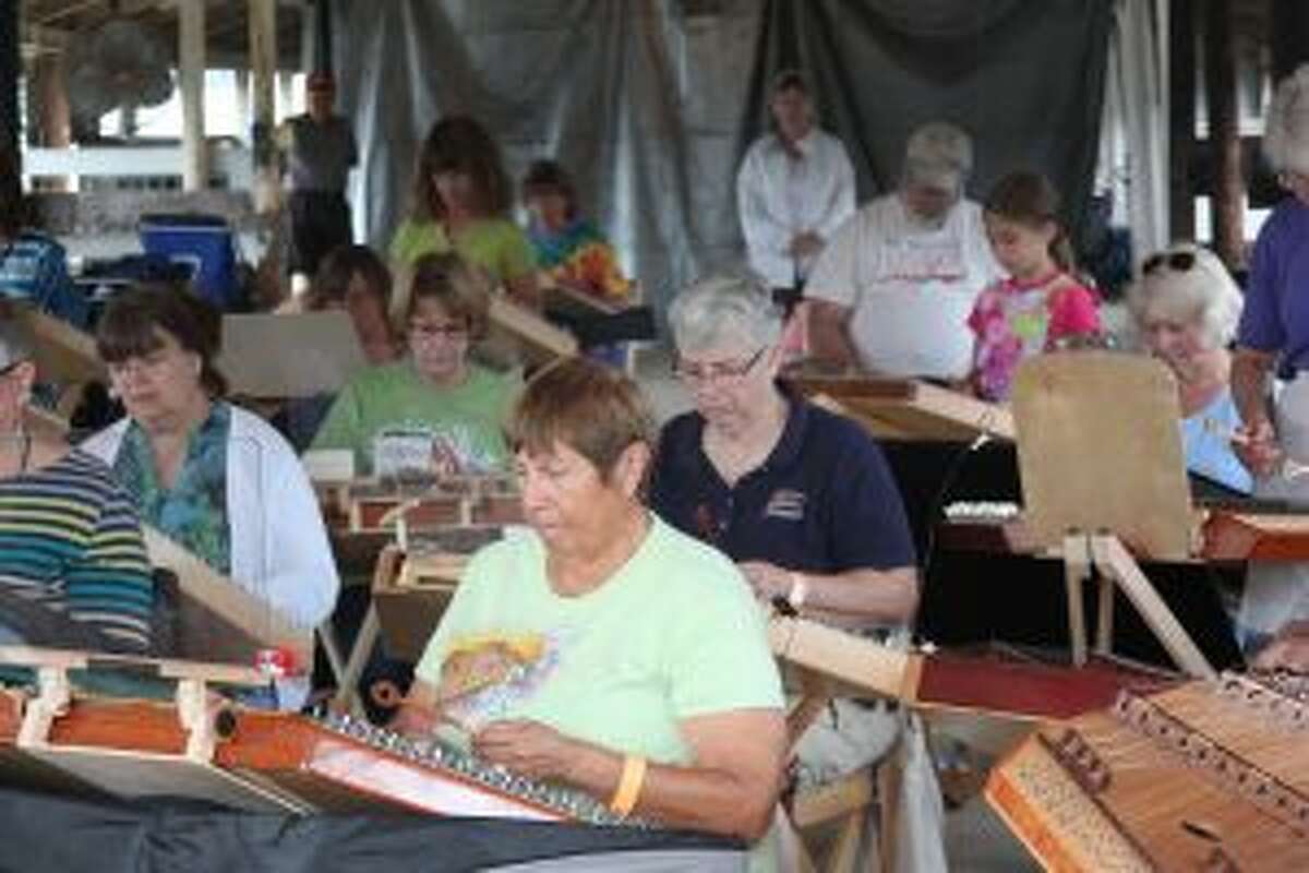 Hammered dulcimer players learn to play hymns during a Pam Bowman workshop Friday morning. The 45th annual Dulcimer Musical Funfest is the largest gathering of players in the country.