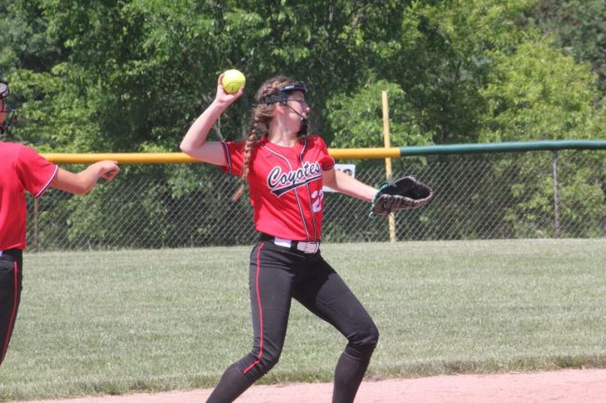 Reed City's Mady Brown throws to first base.