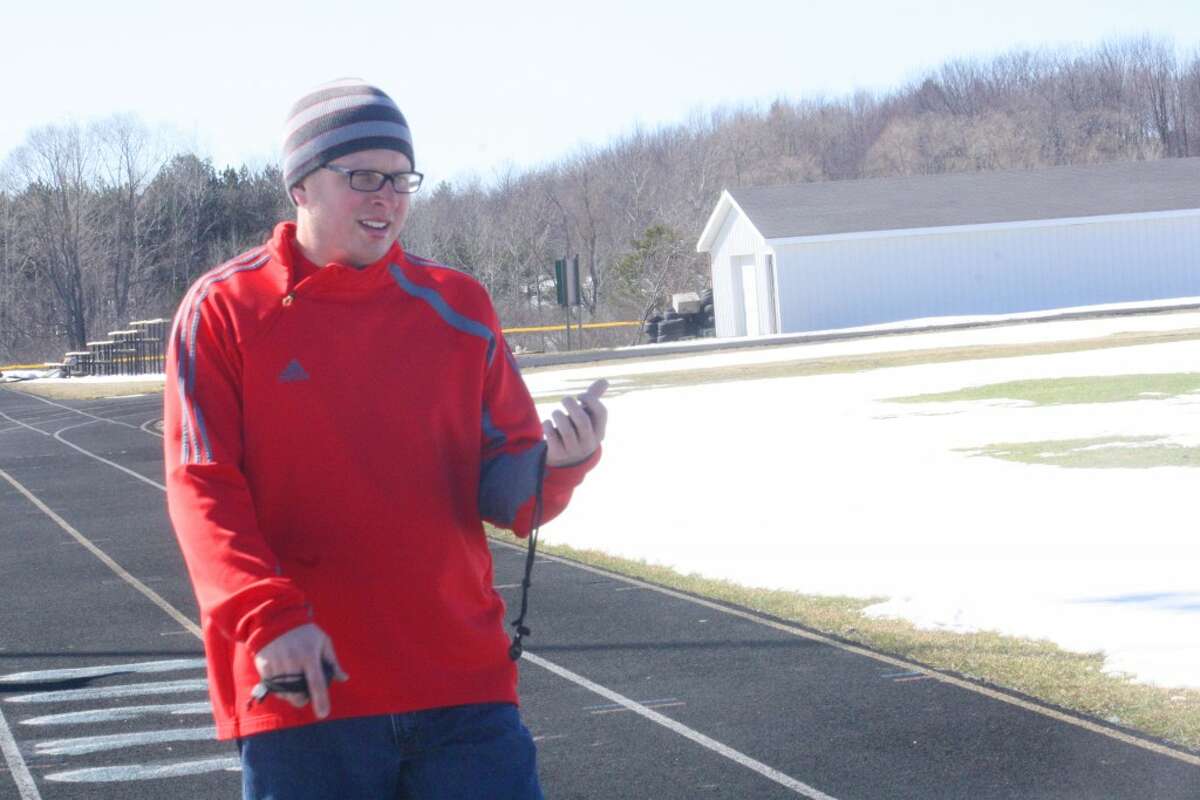 CHAMPIONSHIP GOALS: Eric Gebhard, left, works with his Pine River track team during a recent practice. (Herald Review/John Raffel)