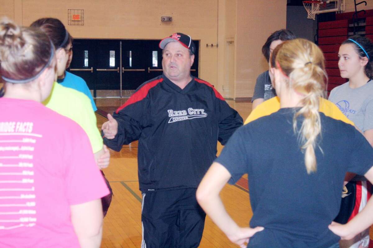 DOING THEIR BEST: Roger Steig talks to his players during an indoor Reed City softball practice. (Herald Review/John Raffel)