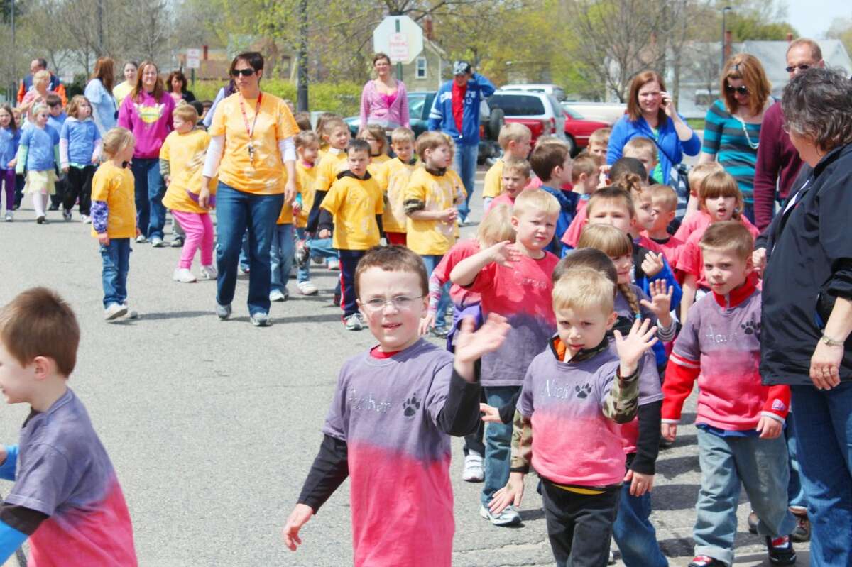 SUPPORTING CHILDREN: Hundreds of students wore colorful t-shirts and walked in last year's Reed City Children's Parade. (File photo)