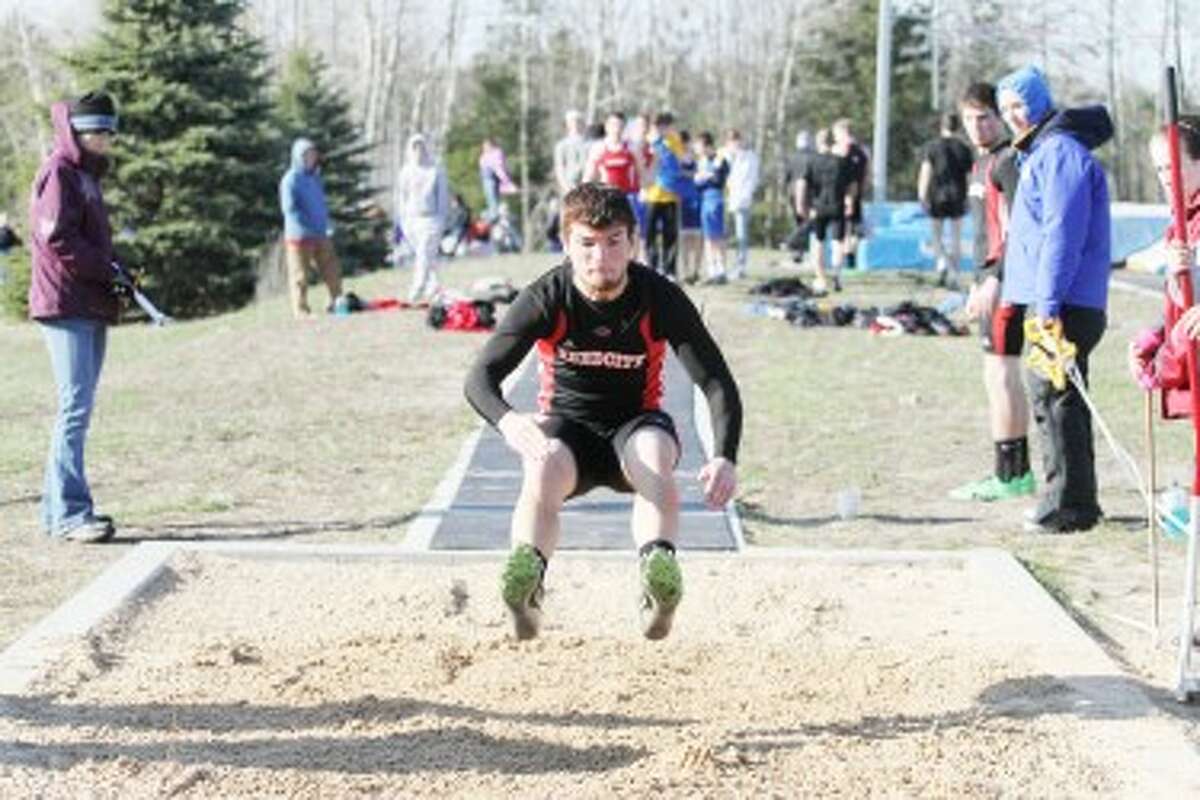 HAPPY LANDING: Reed City's Eric Bradford prepares to land in the long jump during Wednesday's conference track meet at Morley Stanwood High School. (Pioneer photo/Greg Buckner)