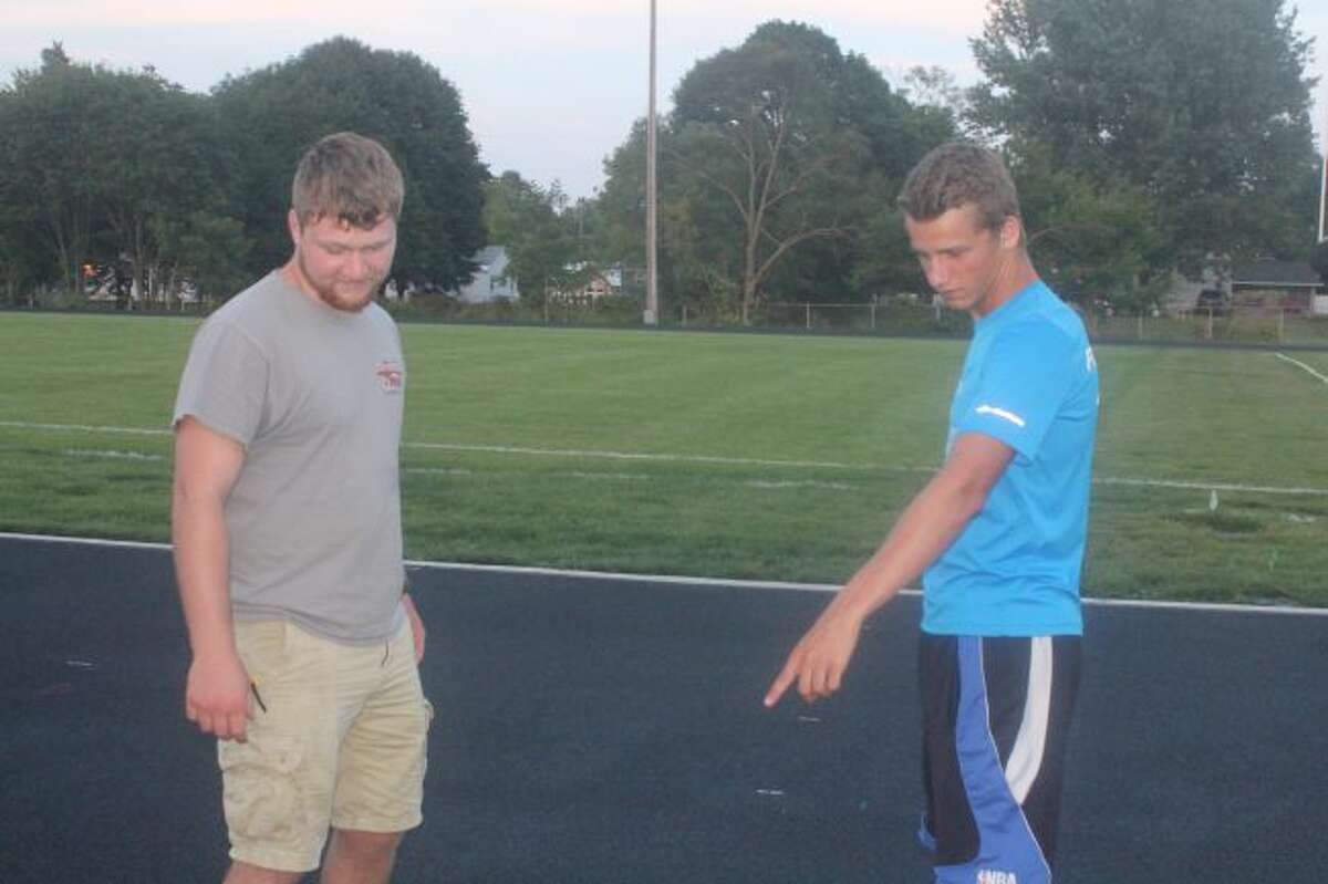 Workers get prepared earlier this summer to put markings on the new Reed City track.