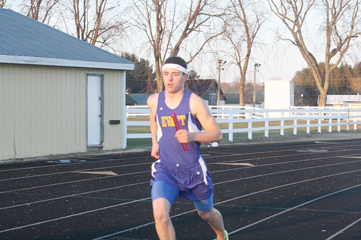 RELAY DASH: John Danley runs his leg of the 1,600-meter relay last week. (Herald Review/John Raffel)