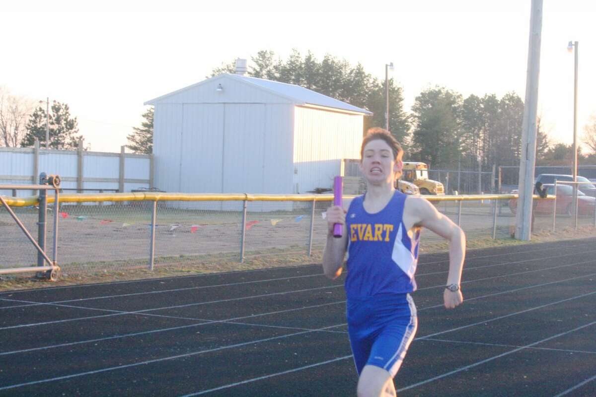 Relay: Logan Hammer gets set to cross the finish line for Evart in the 1,600-meter relay. (Herald Review photo/John Raffel)
