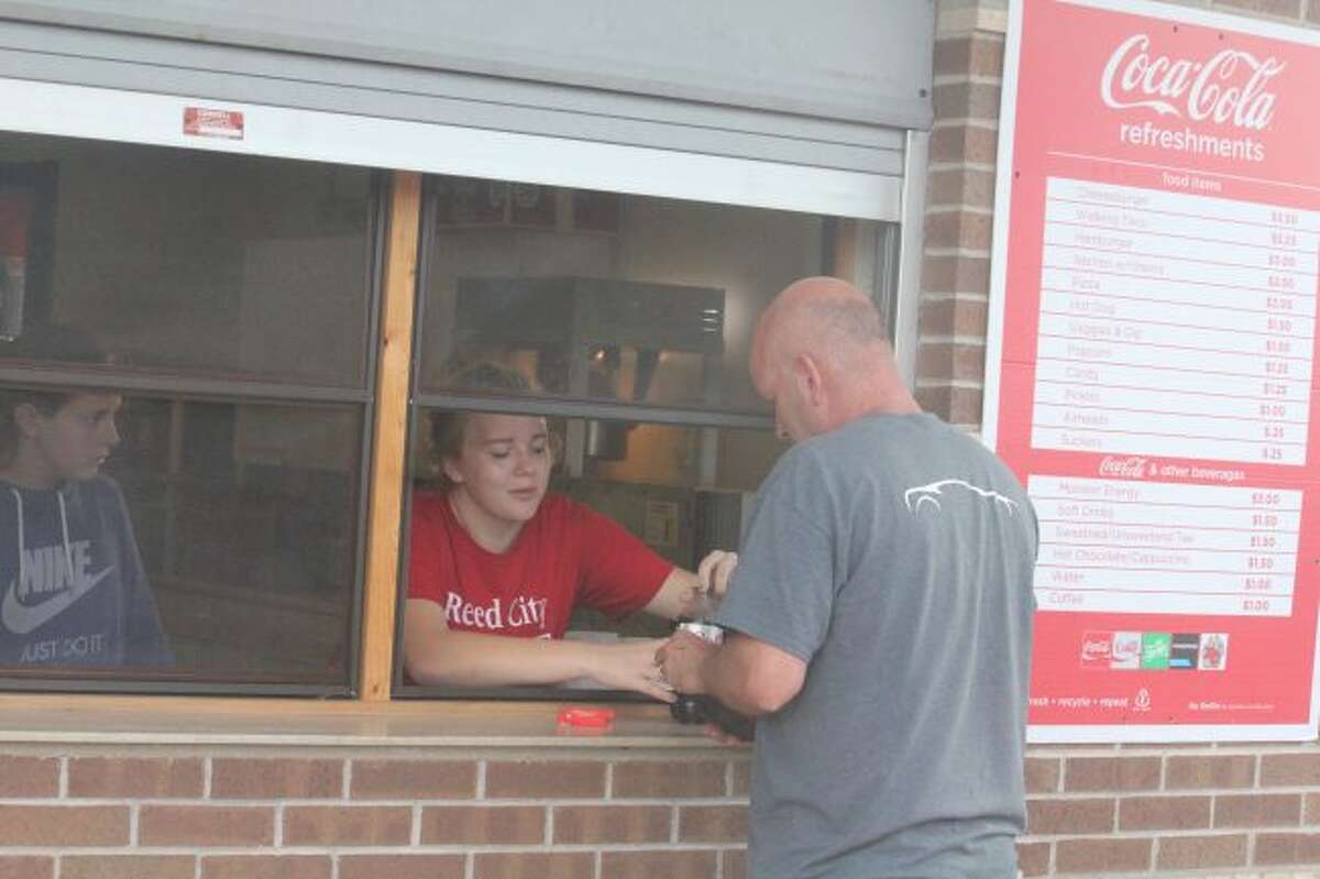 Reed City's Cassie Enos serves a customer during a soccer game.
