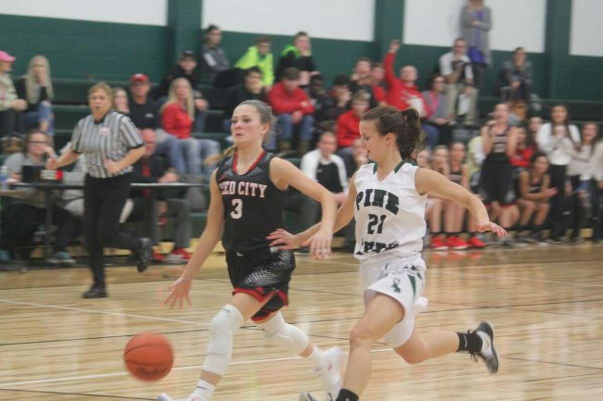 Kamryn Myers heads to the basket against Pine River.
