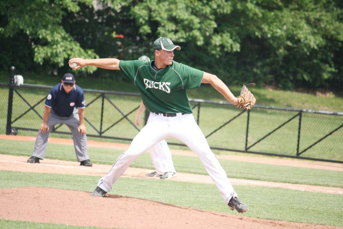 Quarterfinals: Devin Ruppert fires a pitch at the plate against Calvin Christian in Tuesday's quarterfinal game at Michigan State. (John Raffel photo/Herald Review)