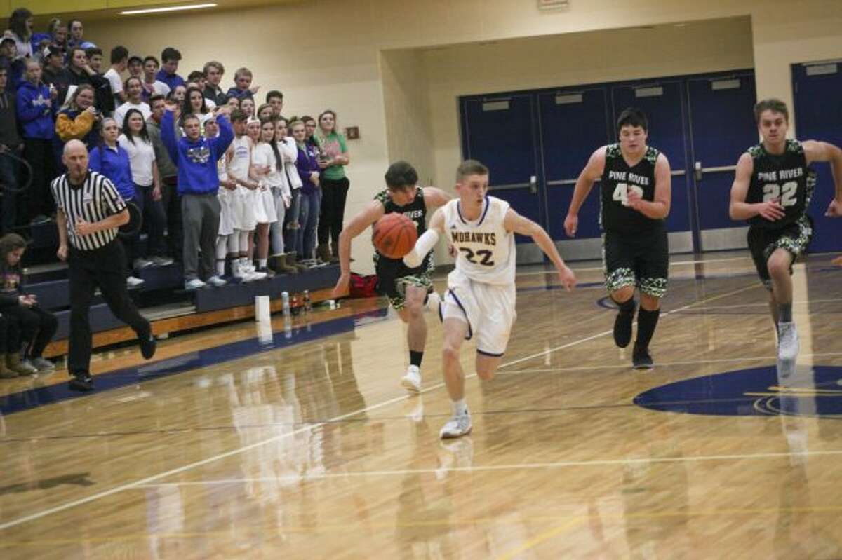 The Pine River defense tries to catch up to the Morley Stanwood ball handler.