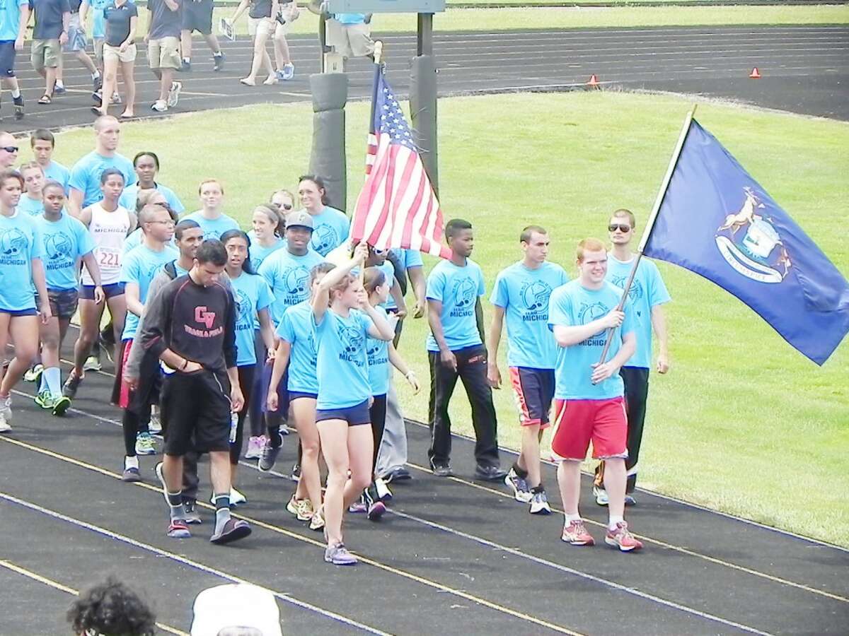 Team captain: Sami Michell was voted team captain by Michigan athletes and carried the American flag at the Midwest Meet of Champions earlier this month in Ford Wayne. (Courtesy photo)