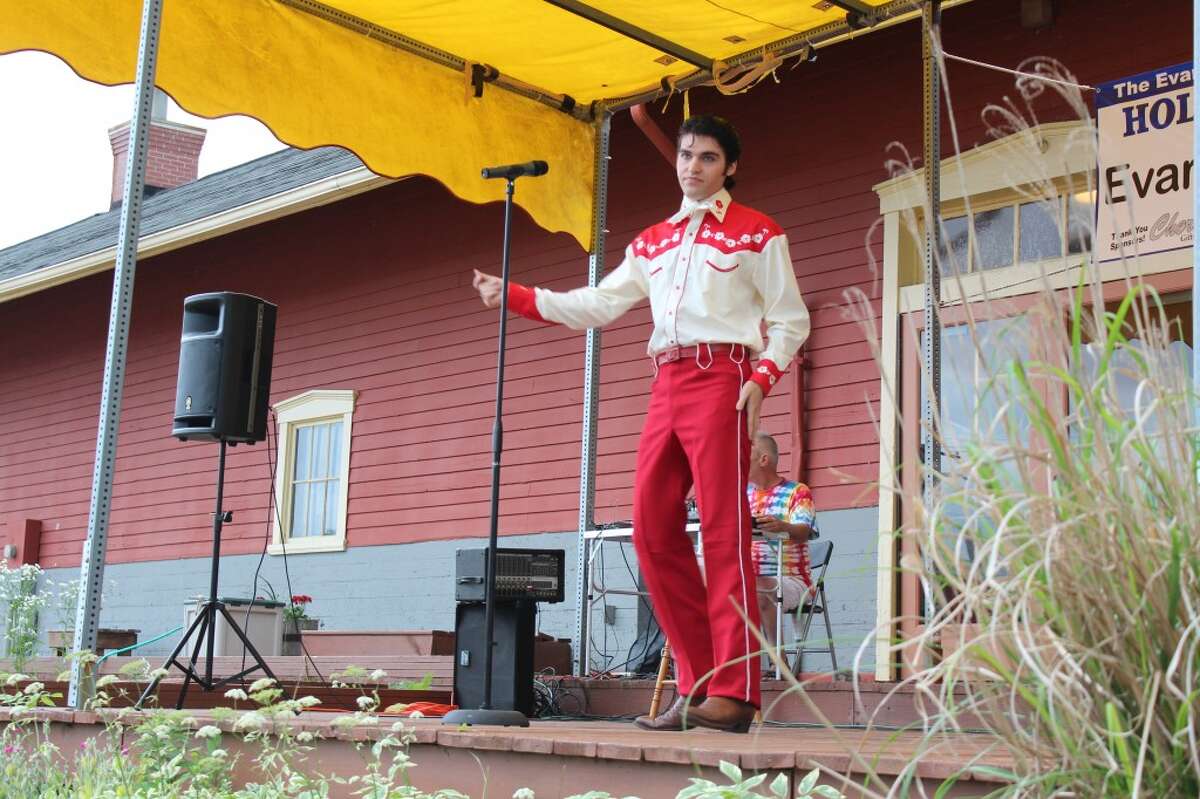 At the show: Hundreds of residents filled the Evart Depot lawn to watch Jake Slater as Elvis on Thursday. (Herald Review photo/Karin Armbruster)