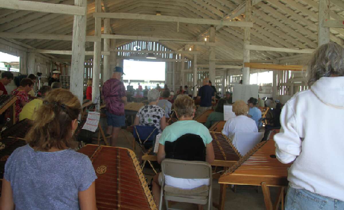 DULCIMER DAYS: (ABOVE) Musicians fill a barn at the Osceola County 4-H FFA fairgrounds to play dulcimers during a workshop at the 2012 Dulcimer Funfest. This year is the 41st annual festival and will be held from Thursday, July 18 to Sunday, July 21 at the fairgrounds. (File photo)