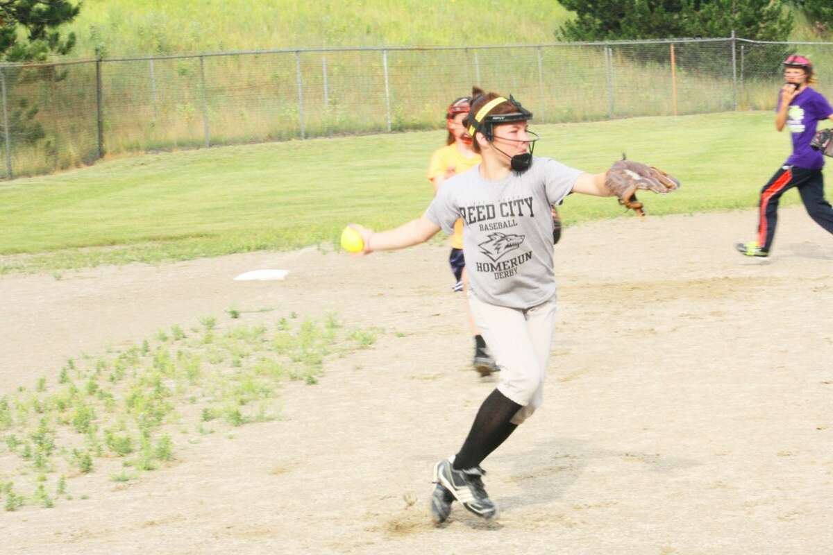 LIttle LEague: Madelyn Morgan gets set to throw the ball to first base during a Reed City-Evart Major girls practice Monday. (Herald Review/John Raffel)