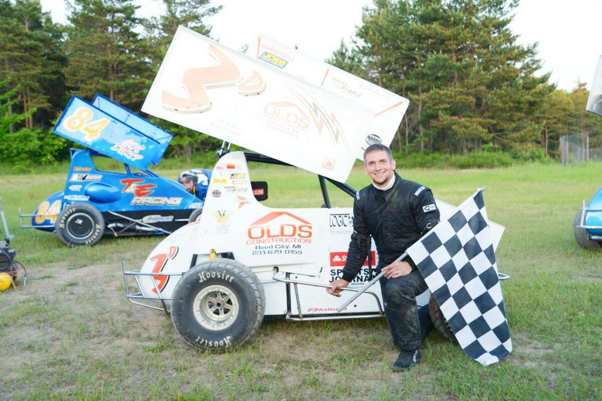 Race car winner: Ricky Droke celebrates a heat victory earlier this summer.(Courtesy photo)