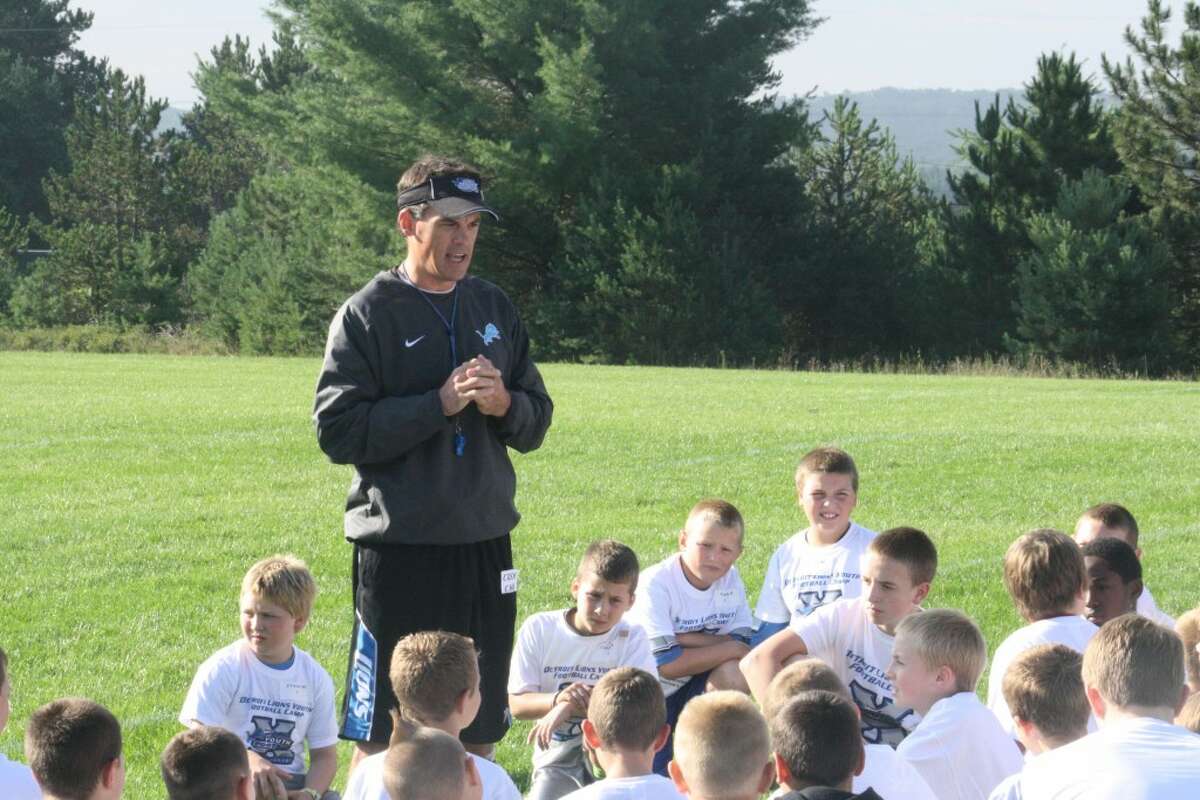 youth football: Chris Fritzsching, director of Detroit Lions Youth Camps, goes over instructions with youngsters Friday prior to the start of the day-long camp. (Herald Review/John Raffel)