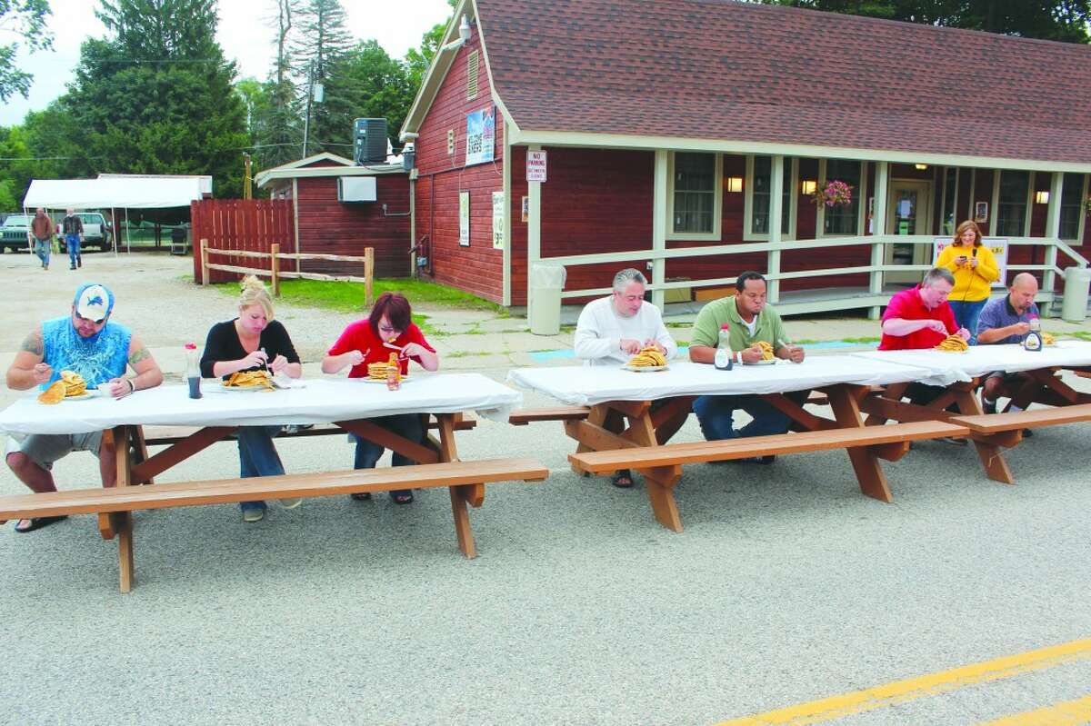 Pancake eating: Brave attendees of last year's Hersey River Town Festival try to eat as many pancakes as possible in a three-minute period. This year, the event will take place at 9 a.m. on Saturday. The River Town Festival takes place Thursday through Saturday. (Herald Review photo)