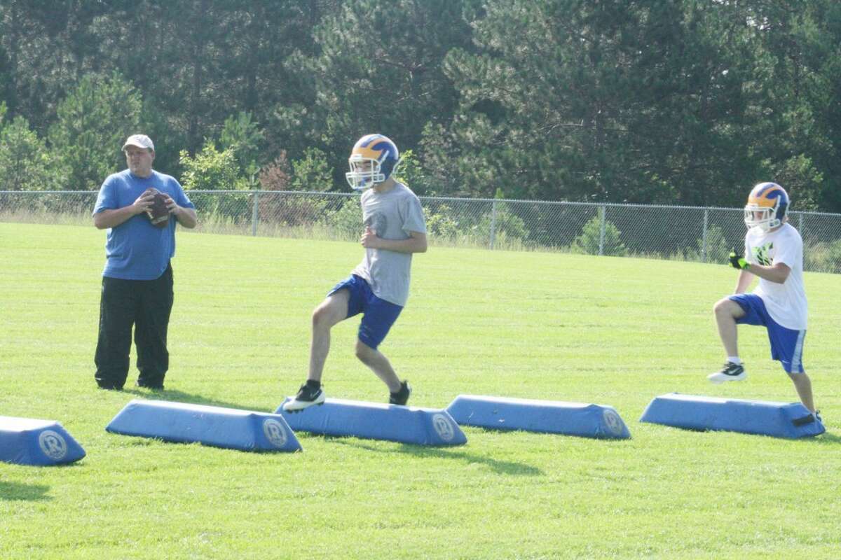 Practice: Evart football players work on a drill Monday. (Herald Review/John Raffel)