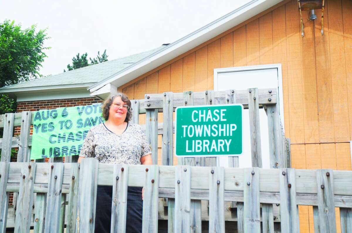 VOTED DOWN: Chase Township Public Library Director Roxanne Ware stands outside of the library on Tuesday, election day. The .25-mil proposed millage to fund library operations was defeated, but Ware says she is optimistic that the library will continue to stay open with the support of the community. (Herald Review photo/Kyle Leppek)