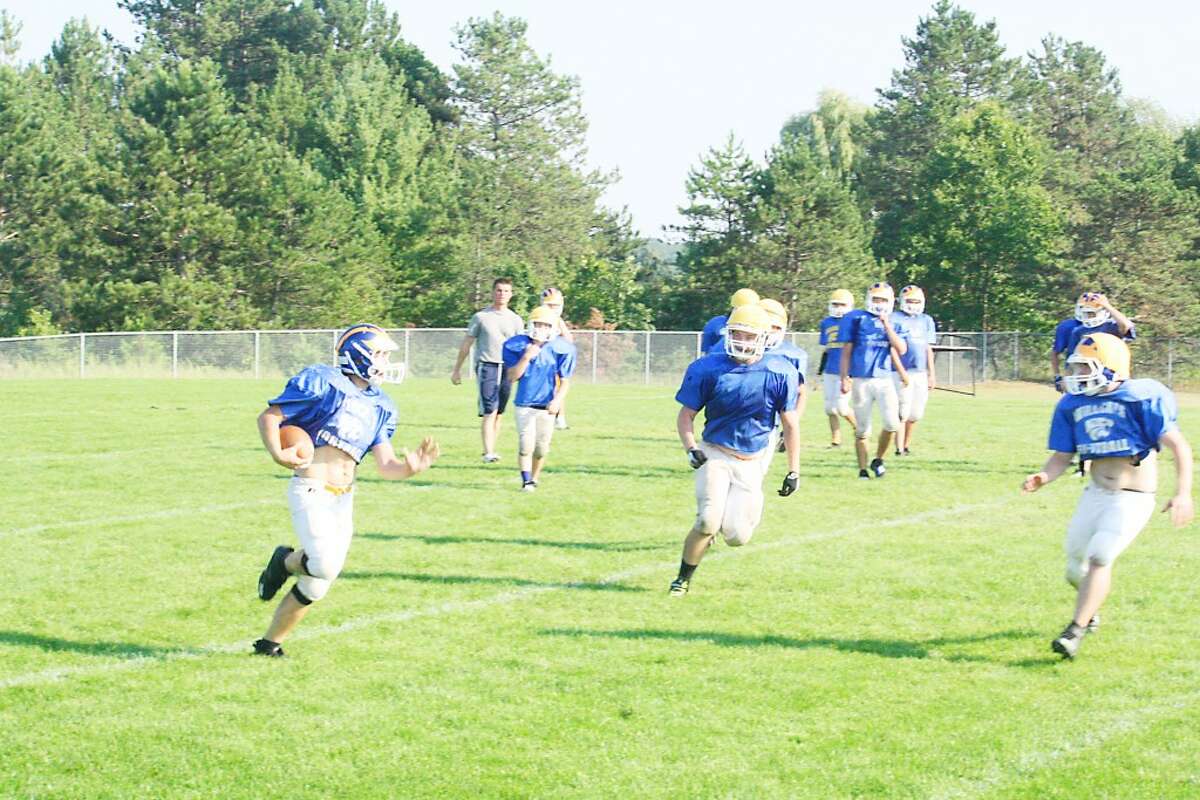 getting ready: Evart football players work on a running play Monday during practice. (Herald Review/John Raffel)