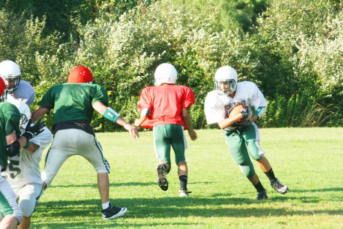 OPENER: Pine River football players work on a running play Monday. (Herald Review/John Raffel)