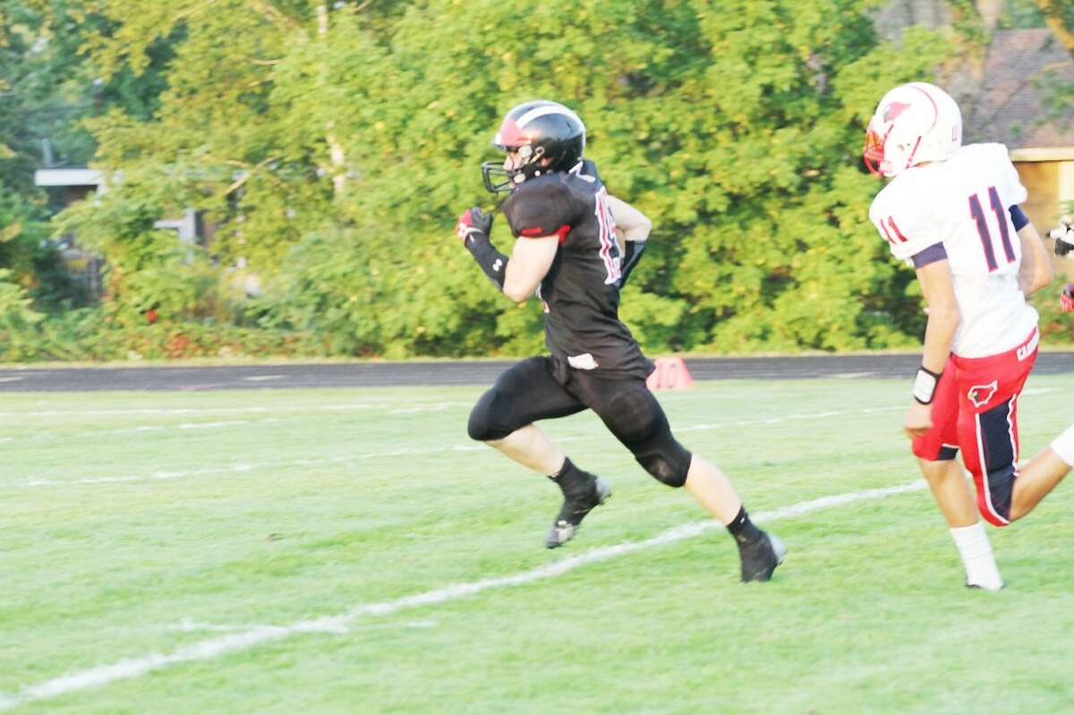 Reed City running back Jon Green (left) pulls away from Big Rapids' Jamison Green during the Coyotes' 39-26 victory over the Cardinals on Thursday. (Herald Review photo/Greg Buckner)