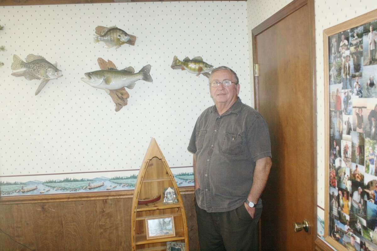 Paul Derscheid’s love of the outdoors is demonstrated by some of his wall hangings at his Pineview Homes office in Evart. (Herald Review/John Raffel)