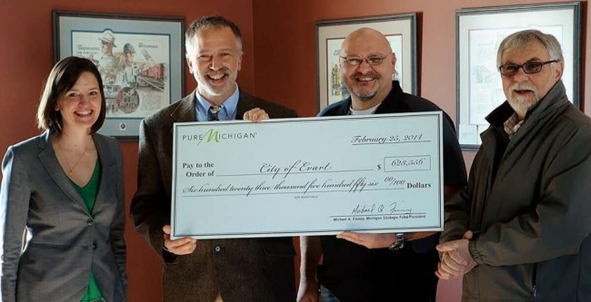 GRANT AWARD: (from left) Karen Keena presents Evart DDA Director Al Weinberg, Evart Mayor Eric Schmidt and Evart City Manager Zack Szakacs (Courtesy photo)