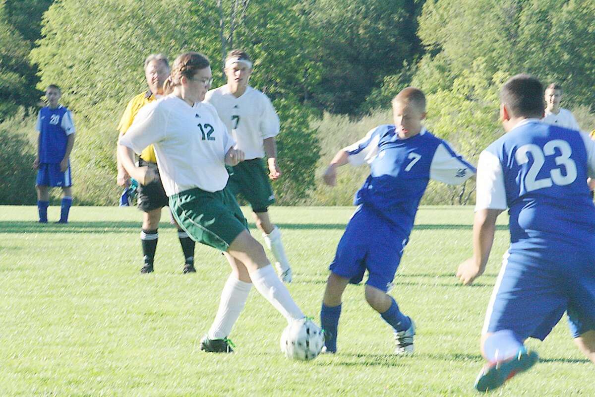Pine River (left) and Gladwin players go after the ball in soccer action last week. (Herald Review/John Raffel)