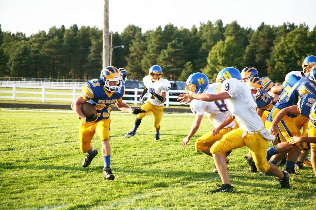 Evart’s Dillon Danley (23) looks for running room against Harrison. (Herald Reviewphoto/Bob Allan)