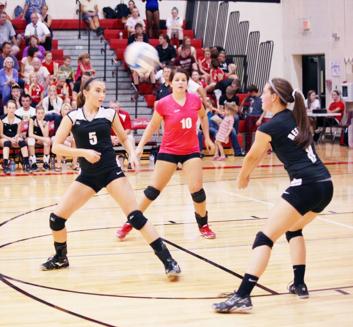Reed City's Kayla Davis (riight) hits a shot while Karah Hensel (10) and Jacolyn Mullins prepare to react in last week's match against Morley Stanwood. (Herald Review photo/Greg Buckner)