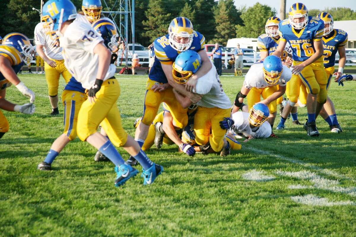 Evart's Larry Van Buren (52) makes the defensive play in recent action for the Wildcats. (Herald Review photo/Bob Allan)