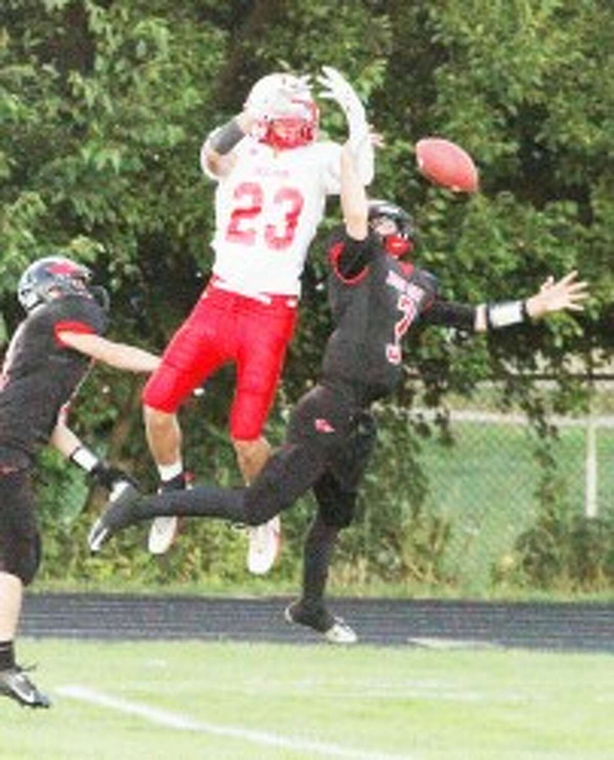 Reed City defensive back Chad Samuels (3) breaks up a pass intended for Holton's Brad Epplett last Friday. (Herald photo/Greg Buckner)
