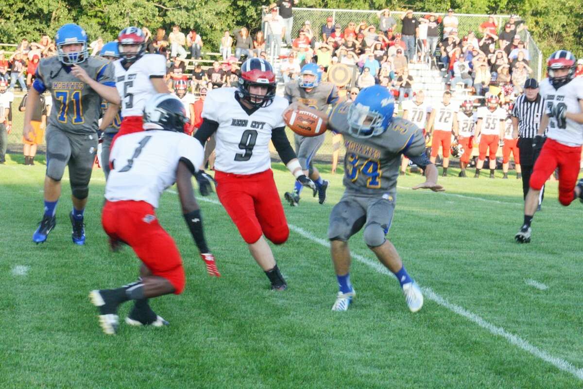 Reed City's Eric Grannis (9) and Paris Jones (1) focus on the runningback in recent action. (File photo)