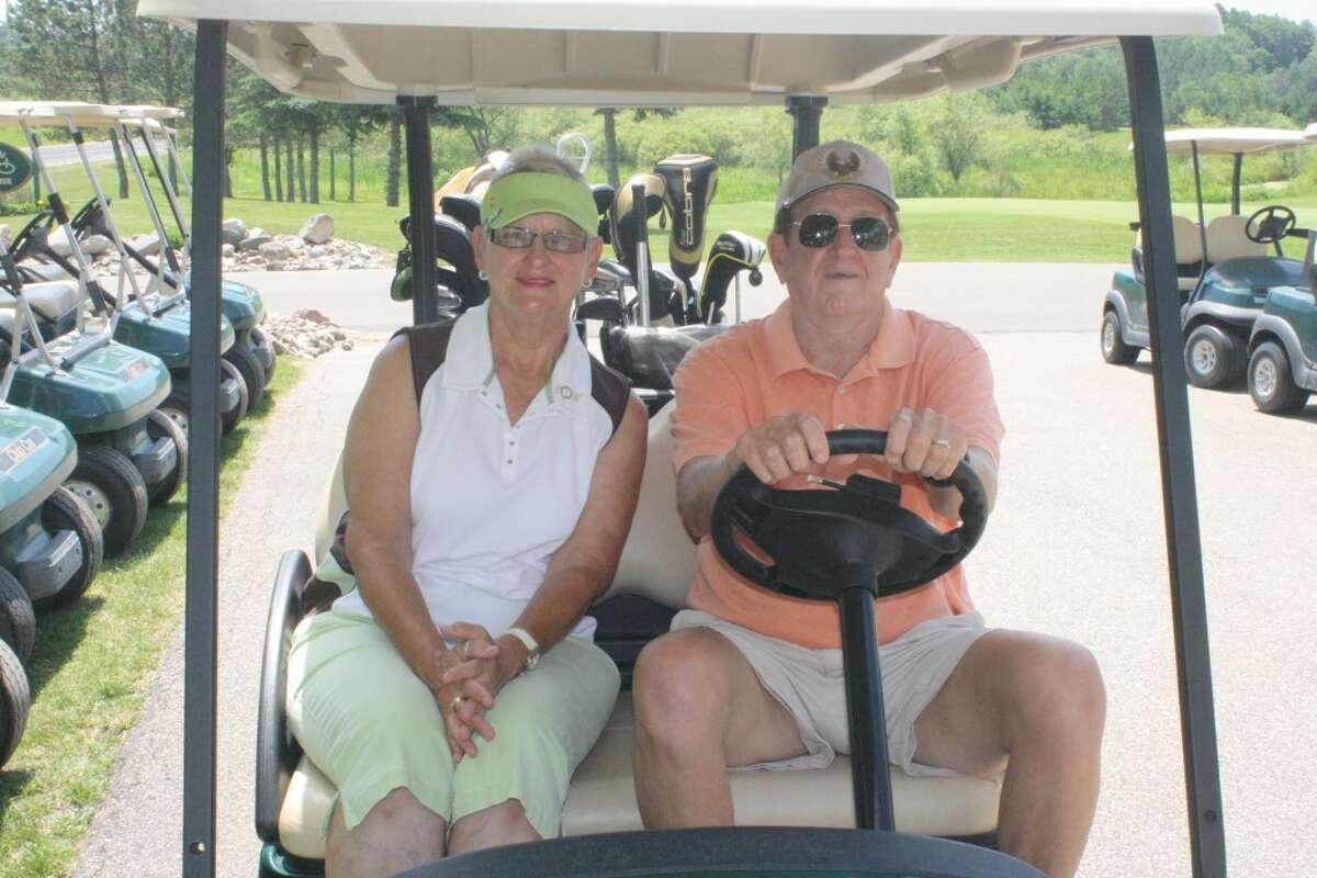 GOOD TIME: Janice Ross and her neighbor and golf partner Tom VanEpps get ready for another round of golf at Tustin Trails Golf Course. (Herald Review photo/John Raffel)