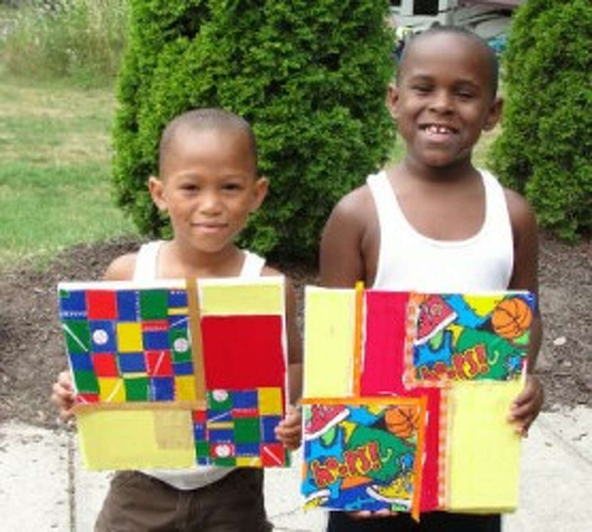 NO. 1: Brothers Marcellus, 5, and Mariano, 6, proudly display their sports themed collages.