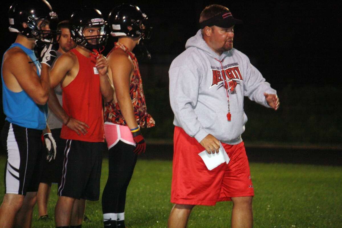 Reed City football coach Monty Price gives instructions during Sunday's midnight madness. (Pioneer photo/John Raffel)