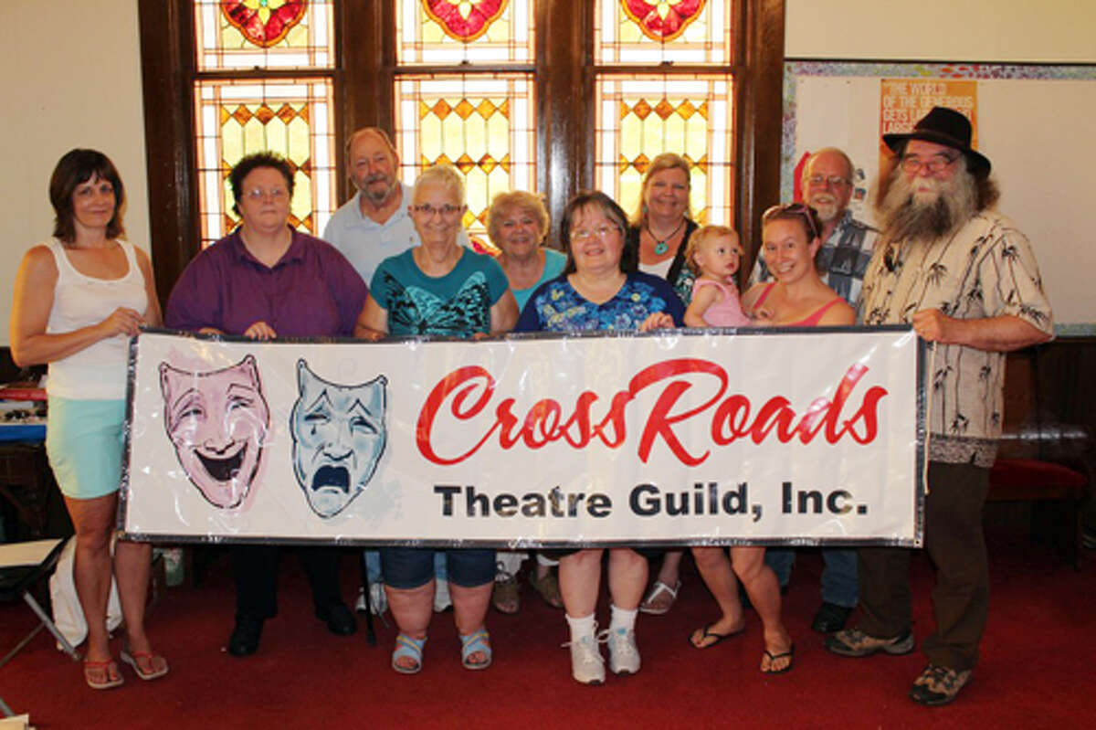 COMEBACK: The Crossroads Theatre Guild will hold auditions Aug. 23 to 25 for 18 parts and volunteers will be accepted for many behind-the-scenes roles. Pictured (from left) is Darlene Fuller, treasurer, Deb Lockwood, president, Ron Ingraham, Linda Backus, secretary, Lois Ingraham, Carolyn Geib, vice president, Shari Ingraham, Sarah Spitzley (holding Leidyn Spitzley), Roger Hicks and Timothy Locker, director. (Herald Review photo/Sarah Neubecker)