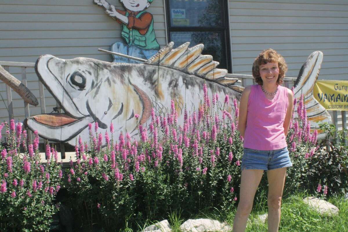ALL ABOUT FISHING: Jolynn Hildrabridle stands in front of the Eyes Have It bait shop in Leroy. (Herald Review photo/John Raffel)